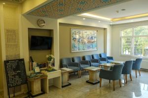 a waiting room with blue chairs and a chalk board at Star Holiday Hotel in Istanbul