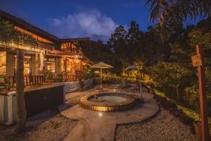 a backyard with a hot tub in front of a house at Selina Monteverde in Monteverde Costa Rica