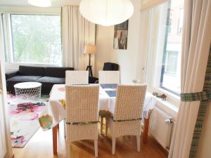 a living room with a table and chairs and a couch at Top Apartments Helsinki - Tilkka in Helsinki