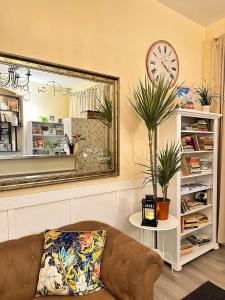 a living room with a couch and a mirror at Explorer Hostel & Apartment Stare Miasto OLD TOWN 24H in Poznań