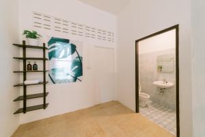 a bathroom with a mirror and a sink and a toilet at Homely Home Khao lak in Khao Lak