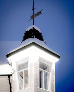 a church steeple with a cross on top of it at Villa Havblikk Tromsø in Tromsø
