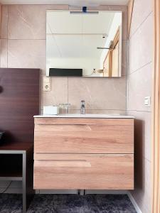 a bathroom with a sink and a mirror at Hotel de Magneet in Hoorn