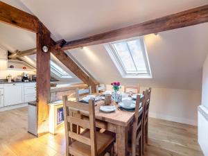a kitchen and dining room with a wooden table and chairs at Flat 5, The Lodge in York