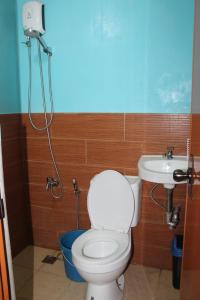 a bathroom with a toilet and a sink at Just Inn in El Nido