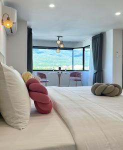 a bedroom with a bed with two stuffed animals on it at Mountain & City View Panorama at Nimman in Chiang Mai