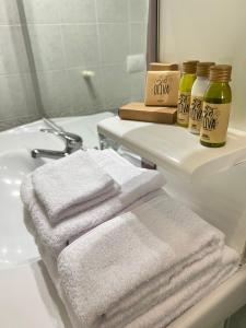 a bathroom with towels and a sink and a mirror at Dimora dei Seclì in Galatina