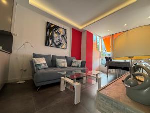 a living room with a couch and a piano at Loris Home playa ingles 50mt from Yumbo by luca properties gran canaria in San Bartolomé de Tirajana