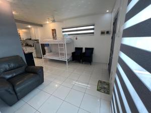 a living room with a black couch and chairs at Grande Villa in Panglao Island