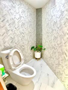 a bathroom with a toilet and a potted plant at Glamping hill khaoyai in Khao Yai +65 photos