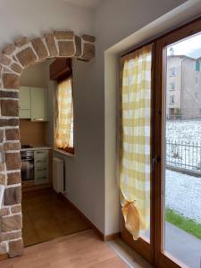 una cucina con arco in pietra accanto a una finestra di LE GEMME ad Andalo