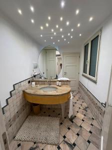 a bathroom with a sink and a mirror at Casa Cavour Viterbo in Viterbo +15 photos