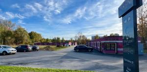 a parking lot with cars parked in front of a building at Diament Ruda Śląska in Ruda Śląska