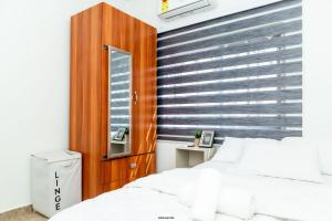 a bedroom with a bed and a wooden headboard at Hallet Homes VIII - East Legon, Accra in Accra
