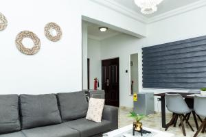 a living room with a couch and a table at Hallet Homes VIII - East Legon, Accra in Accra