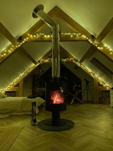 a fireplace in a room with lights on the ceiling at Bedport Loft in Burrington