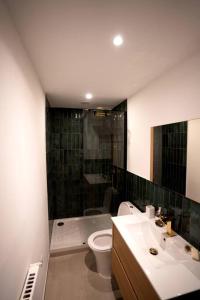 La salle de bains est pourvue de toilettes, d'une douche et d'un lavabo. dans l'établissement Appartement avec jardin proche mer, à Antibes