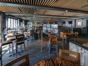 a restaurant with tables and chairs and a bar at Suite residence at Grand Colorado on Peak 8 in Breckenridge