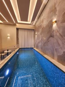 a swimming pool in a hotel with a marble wall at תבל PRIVATE HOTEL in Jerusalem