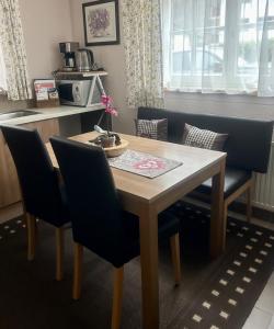 a dining room table with blue chairs and a table at Landhaus Ostermann in Umhausen