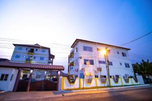 a street corner with a building and a street light at Stylish East Legon Apartment - AC, Wi-Fi, Netflix in Accra