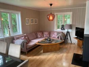 a living room with a couch and a coffee table at At The Lakeside II in Skulestadmo