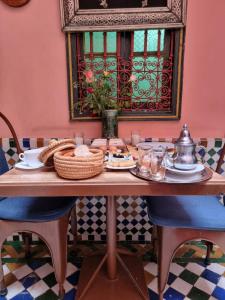 a table with a basket of food on it at Casa del Sol Marrakech in Marrakech