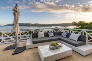 a patio with a couch and an umbrella at 6 On Protea in Knysna