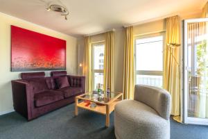 a living room with a couch and a glass table at Villa Strandperle, App 04 - nur 20m zum Strand, TOPLAGE in Binz