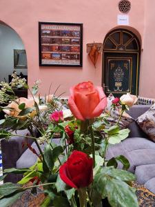 a bouquet of roses in a room with a couch at Casa del Sol Marrakech in Marrakech