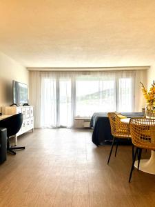 a bedroom with a bed and a table and chairs at Little Penthouse **** in Dietikon