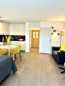 a kitchen and a living room with a table and chairs at Little Penthouse **** in Dietikon