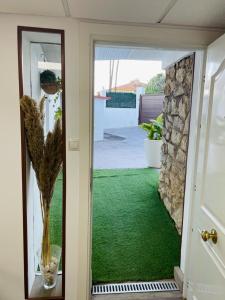 a room with a door with a green floor at Luxury apartament airport in Málaga