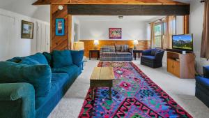 a living room with a blue couch and a rug at 1BR Rustic Retreat Near Trails and Slopes in Dillon