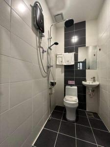 a small bathroom with a toilet and a shower at R Hotel Langkawi in Kuah
