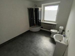 uma casa de banho com um lavatório, um WC e uma janela. em Fantastic - NW30 Room C em Varsóvia