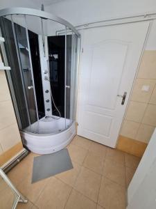 uma casa de banho com um chuveiro e uma porta de vidro em Fantastic - NW30 Room C em Varsóvia