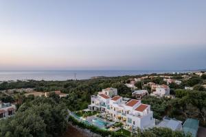 an aerial view of a resort with the ocean in the background at Coconut Palm Paradise in Gállos