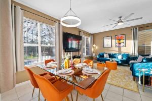 a dining room and living room with a table and chairs at Pool - Life Size Games - 25 mins to Disney World in Davenport