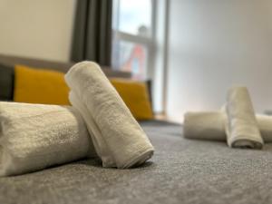 three rolled up towels sitting on the floor at Cosy and Homey 1br flat in Sunderland Centre - Flat 2 in Sunderland
