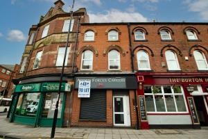 a brick building on a city street with a store at Cosy and Homey 1br flat in Sunderland Centre - Flat 2 in Sunderland