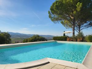a swimming pool with a view of the mountains at Villa with Pool and Countryside View in Montefalco