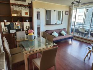 a living room with a glass table and a couch at Departamento San Pedro de la Paz in San Pedro de la Paz