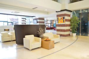 a lobby with chairs and a table in a building at Flamingo Grand Hotel & Spa in Albena