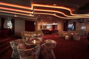 a room with chairs and a table with candles at Flamingo Grand Hotel & Spa in Albena