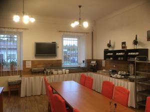 a dining room with a table and red chairs at Pokoje RELAX in Rybniště