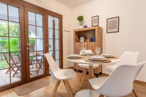 a dining room with a table and chairs and a balcony at Apartamento Clover in L'Escala