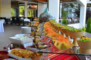 a buffet of food on a table with food at Flamingo Grand Hotel & Spa in Albena
