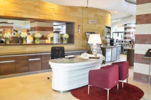 a bar in a store with chairs and a counter at Flamingo Grand Hotel & Spa in Albena