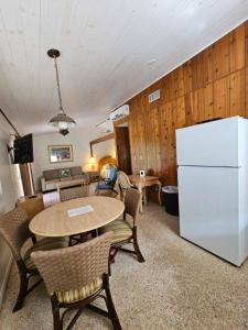 a living room with a table and a white refrigerator at Tropical Marina & Resort on Lake Beresford in De Land